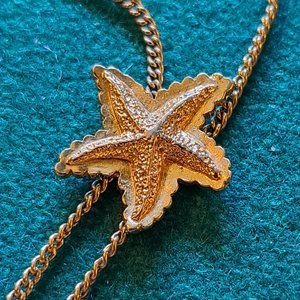 Vintage '82 Avon gold tone starfish lariat style necklace.
